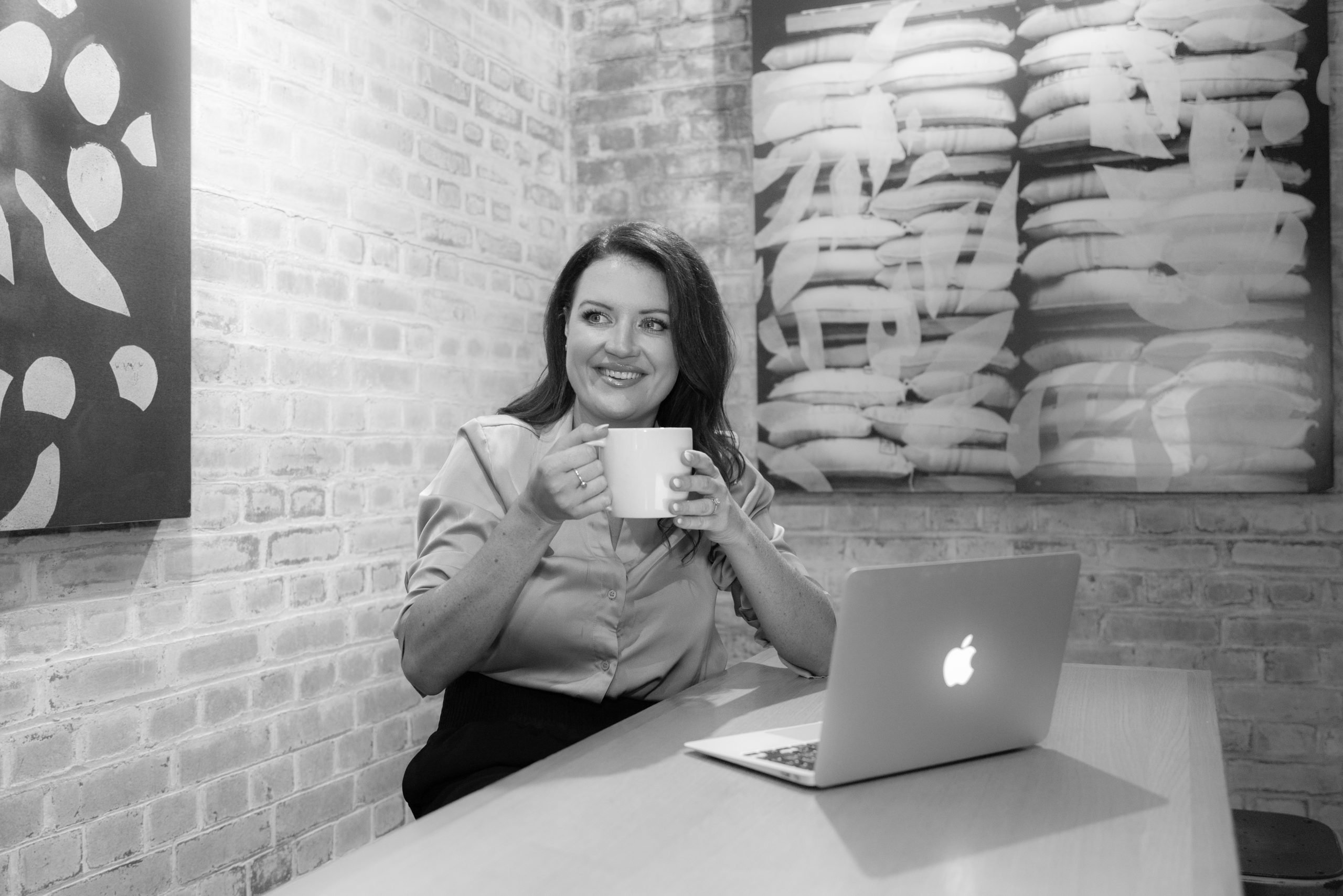 Becky working at her laptop with a coffee