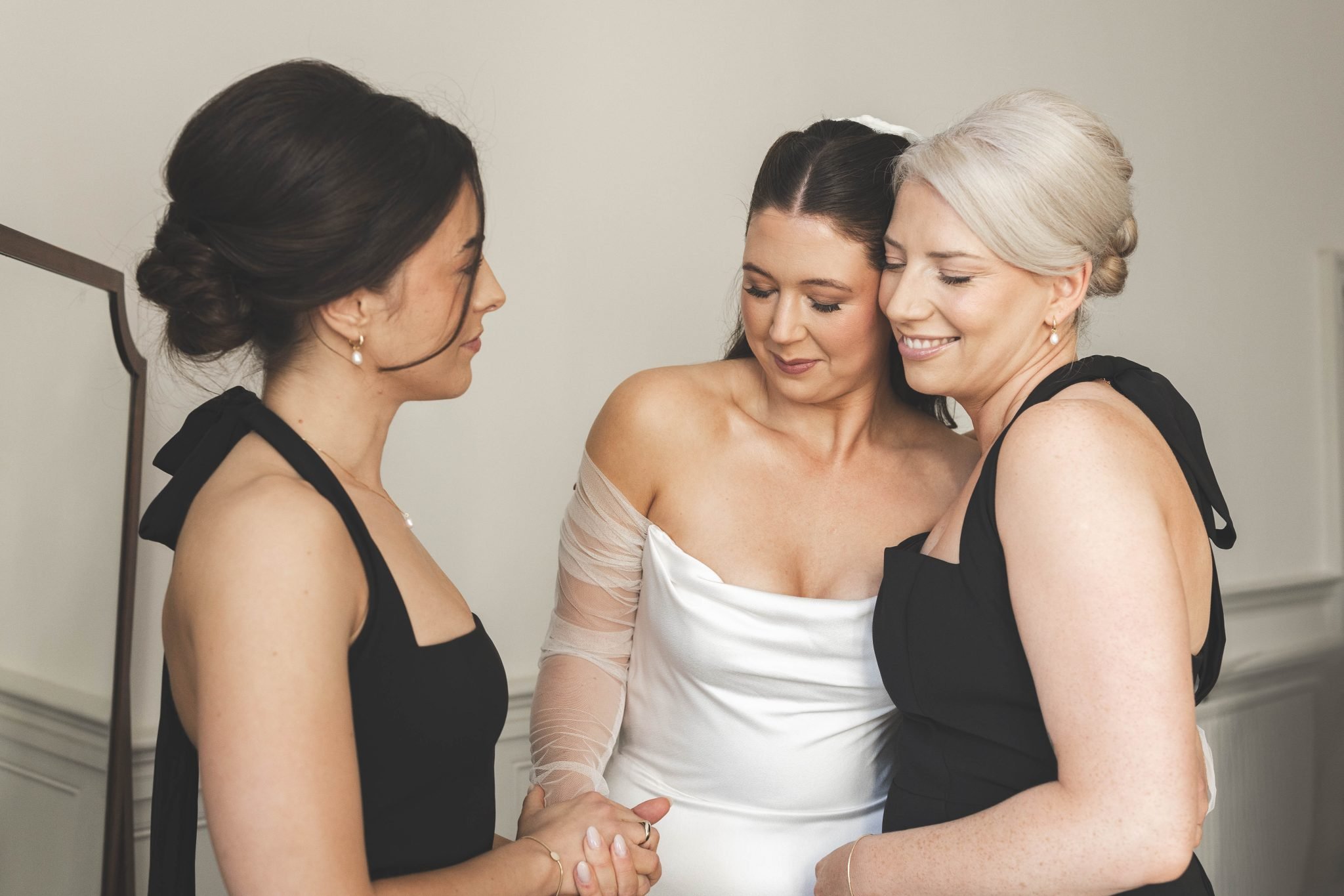 A Rosebud bride sharing an emotional moment with her bridesmaids